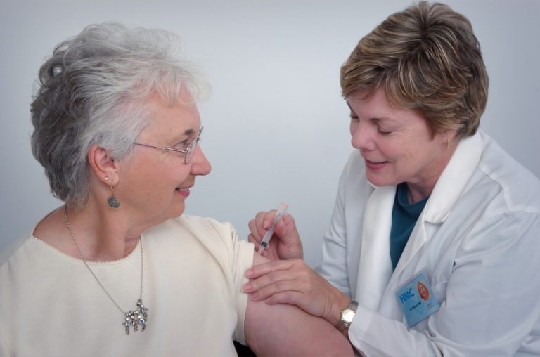 Doctor administering a vaccine to a patient