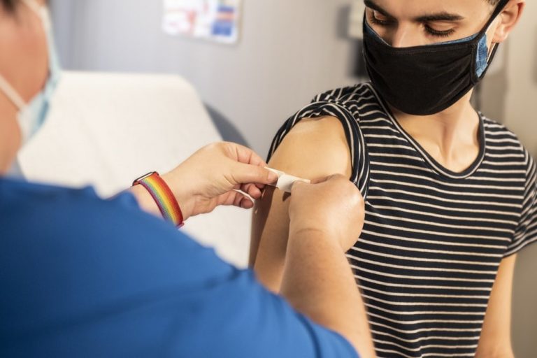 A health care professional vaccinating a person against a virus.