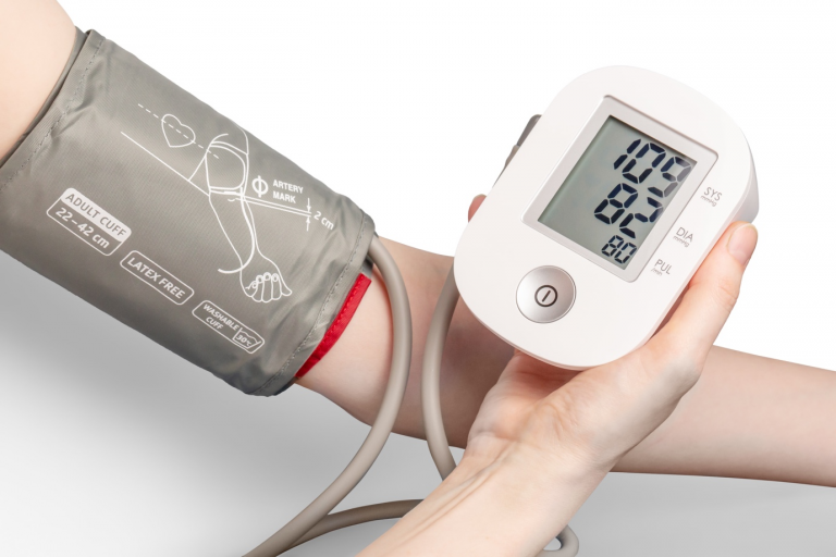 A person checking his blood pressure on a digital machine