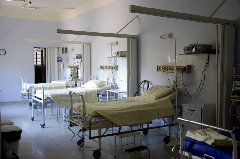 A hospital room with multiple beds