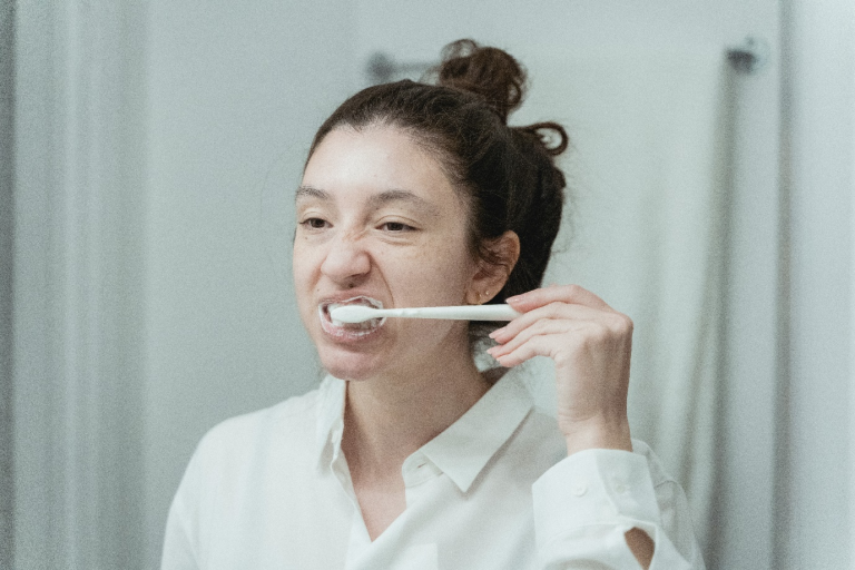 a woman brushing her teeth