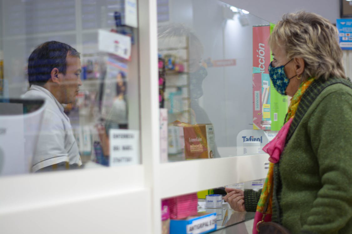 A person buying prescription medicine at a pharmacy