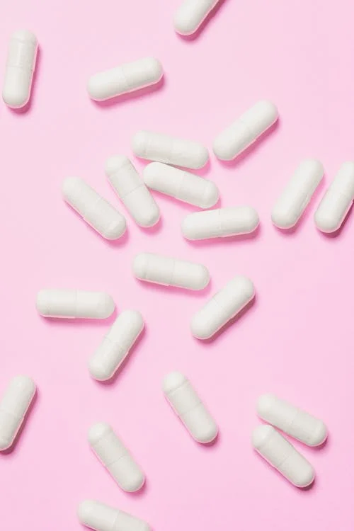 A bottle of Cymbalta capsules on a pink background.