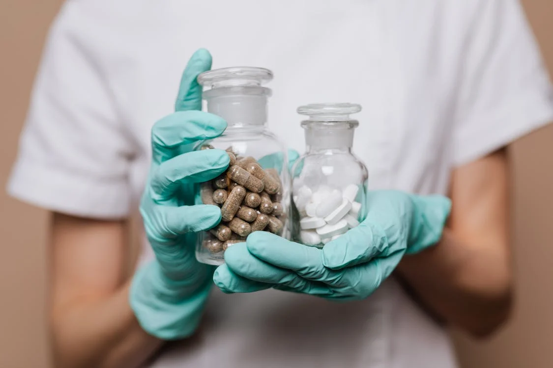 A doctor holding jars of medicine