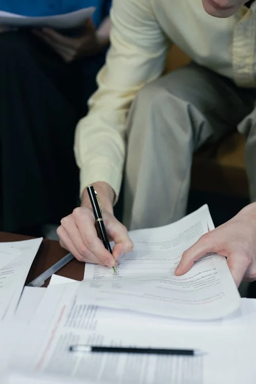 A person filling out a prescription assistance application form