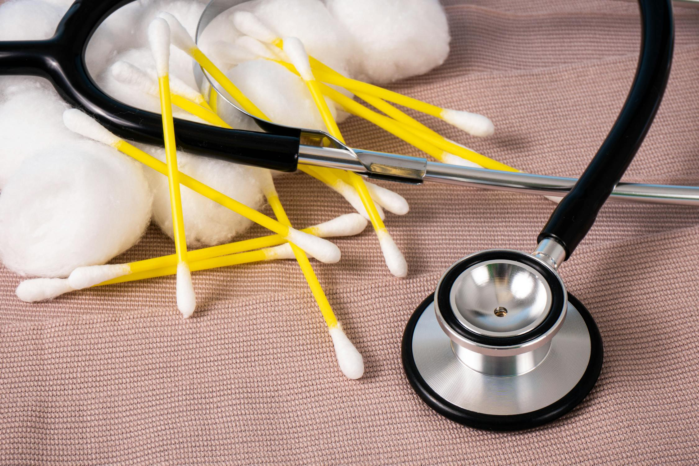 A stethoscope with cotton swabs