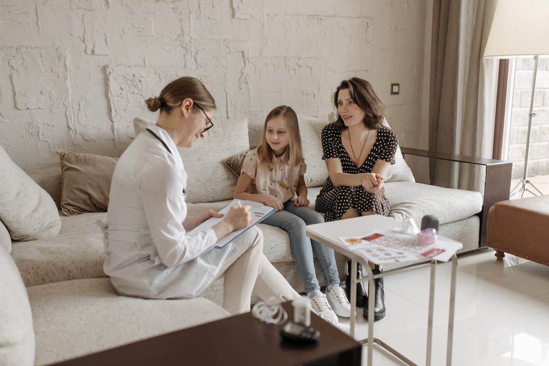 Doctor consulting with a mother and her daughter during a medical appointment