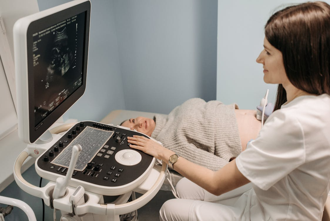 Healthcare professional conducting an ultrasound on a pregnant woman