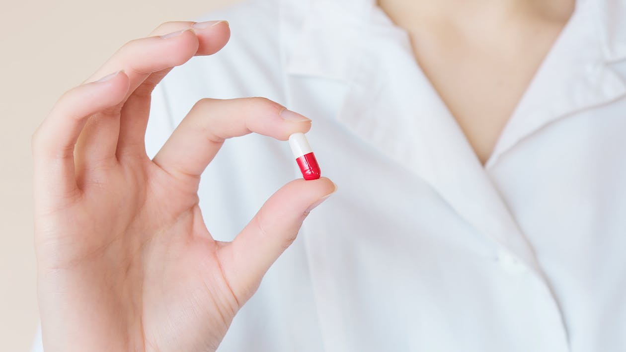 A person holding a prescription pill