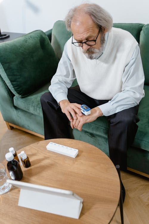 A man sitting on a sofa chair, reflecting comfort at home.
