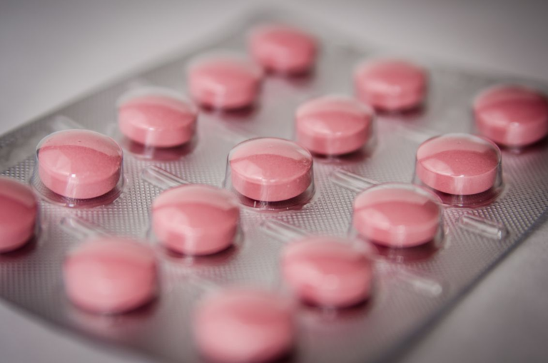 Close-up of round pink prescription medication pills.