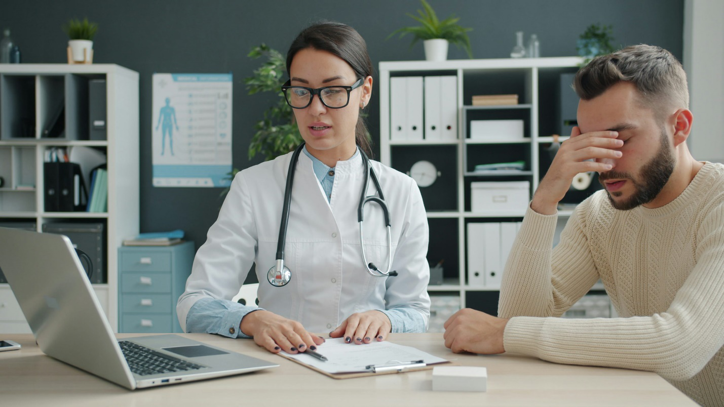 Worried patient waiting at pharmacy counter due to prescription delay