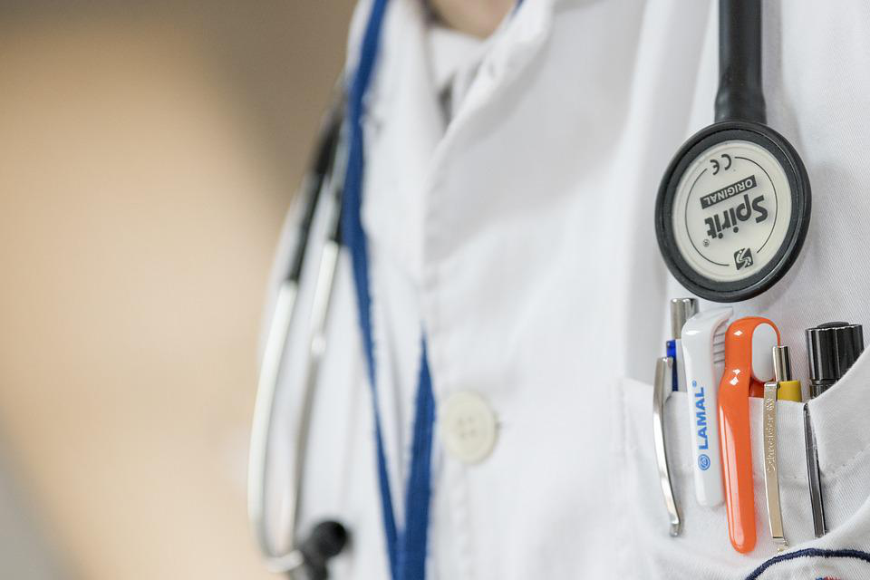 Abstract hospital and medical staff scene representing the broader healthcare system structure