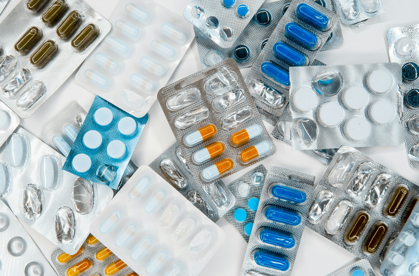  Assorted medicines and prescription bottles arranged on a table in a clinical setting