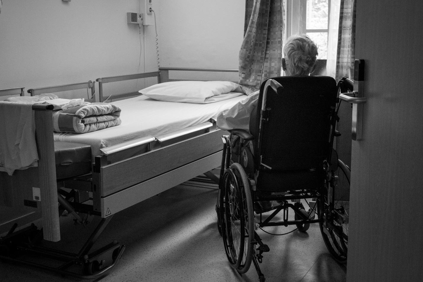 Patient in wheelchair being discharged from hospital with caregiver support