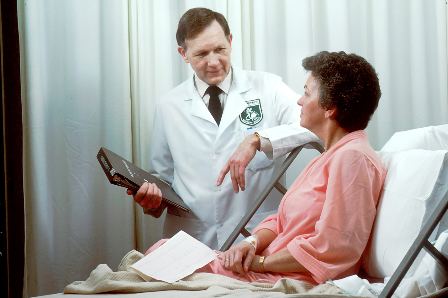 Doctor discussing treatment and medication plan with patient during consultation