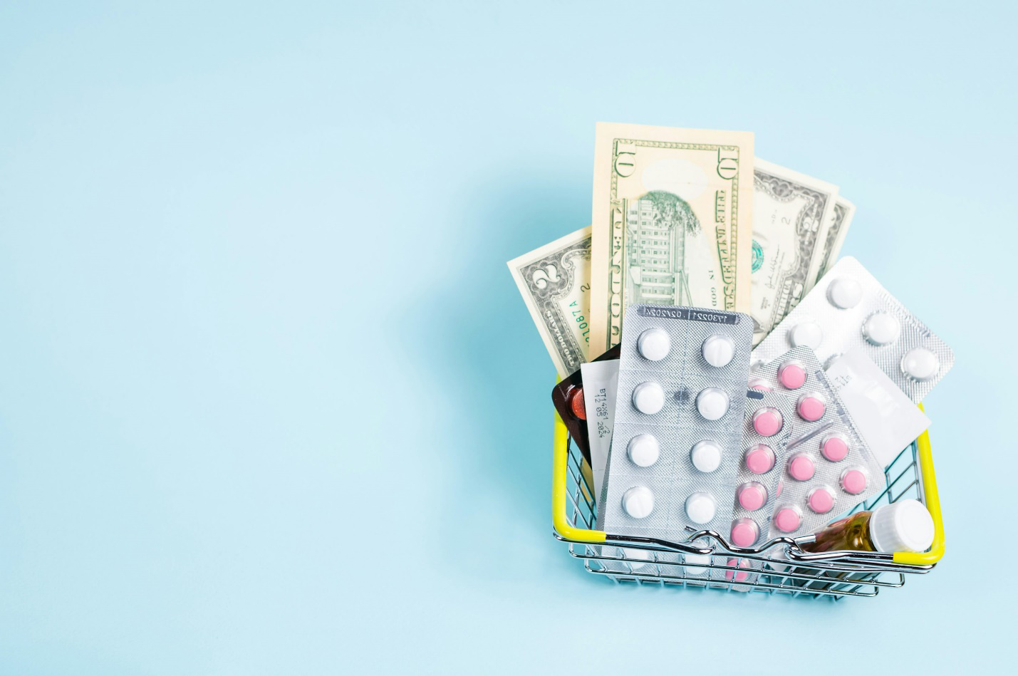 Prescription medicines alongside bills and calculator representing medication costs and affordability concerns