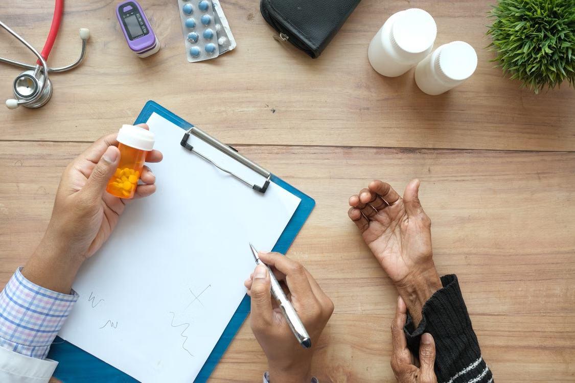 Doctor reviewing a patient's prescription and medication during a medical consultation