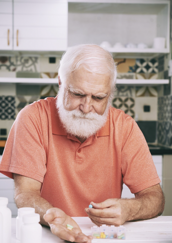 Older man taking prescription medication.