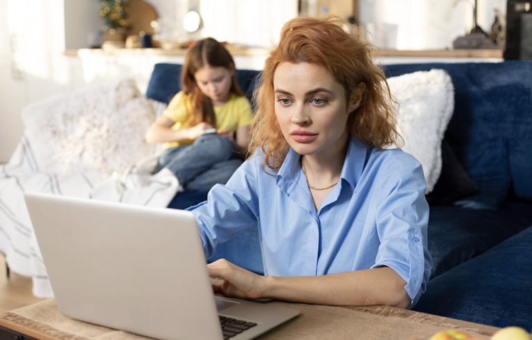 Woman using a laptop at home while completing a prescription assistance enrollment application.