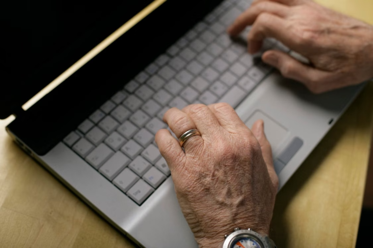 lder adult using a laptop to manage prescription medications online