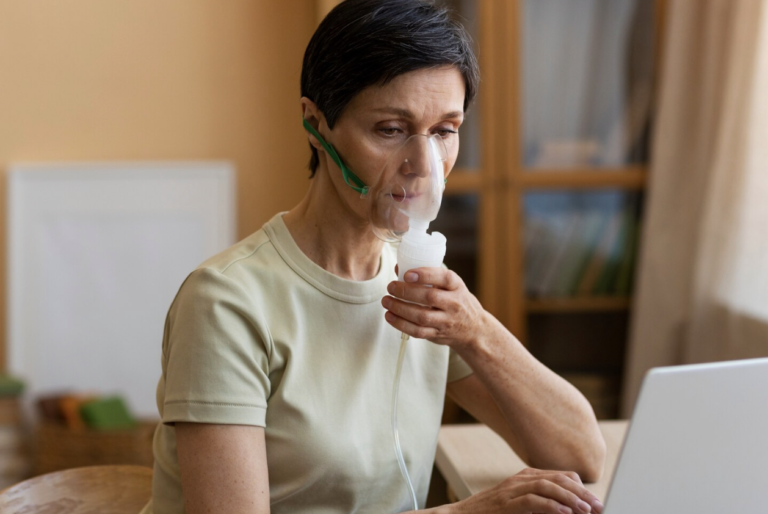 Older woman using respiratory treatment as part of ongoing care for a chronic condition.