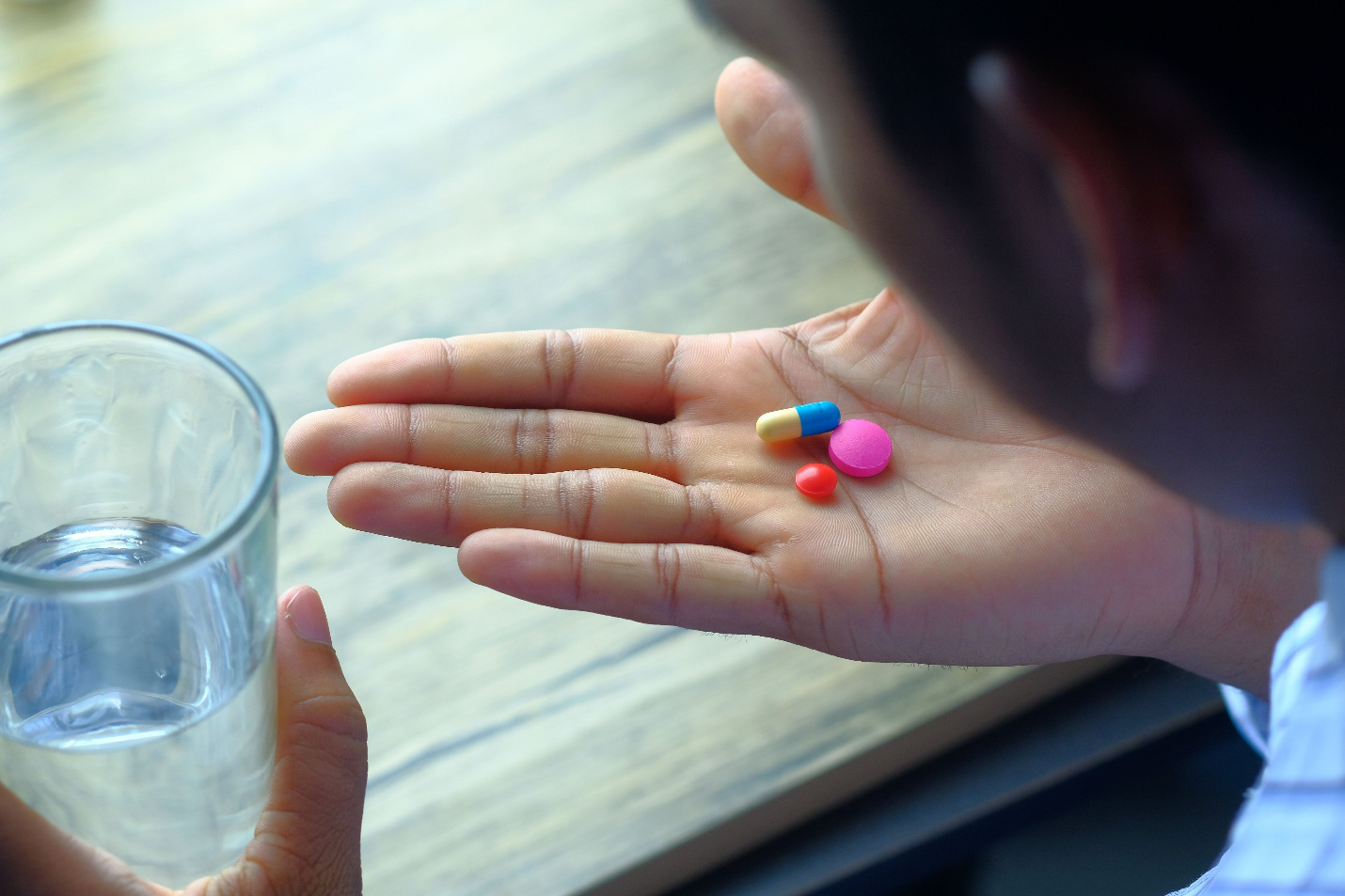 Patient holding prescription medications while considering assistance eligibility